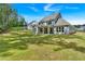 Expansive backyard showcasing a well-maintained lawn, mature trees, and partial views of the home's exterior at 1114 Low Water Crossing Nw, Acworth, GA 30101