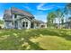 Spacious backyard featuring lush green grass and an outdoor patio area, ideal for enjoying the outdoors and entertaining guests at 1114 Low Water Crossing Nw, Acworth, GA 30101