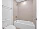 Bathroom features a shower and tub with light beige tile surround at 1114 Low Water Crossing Nw, Acworth, GA 30101