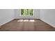 Bedroom features hardwood floors and a sunlit window at 1114 Low Water Crossing Nw, Acworth, GA 30101