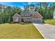 Beautiful two-story home featuring brick, stone accents, a well-manicured lawn and an attached two-car garage at 1114 Low Water Crossing Nw, Acworth, GA 30101