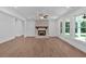 Spacious living room featuring a brick fireplace, ceiling fan, recessed lighting, and large windows at 1114 Low Water Crossing Nw, Acworth, GA 30101