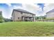 Beautiful backyard featuring a well-manicured lawn and an outdoor cabana at 116 Chorley Run, Ellenwood, GA 30294