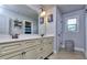 Bright bathroom with a double vanity, a large mirror, and decorative wall art, offering a serene space at 116 Chorley Run, Ellenwood, GA 30294