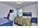 Well-lit bedroom with a comfortable bed, a desk for gaming, and a ceiling light, offering a functional space at 116 Chorley Run, Ellenwood, GA 30294