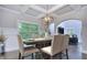 Dining room features hardwood floors, coffered ceiling, modern light fixture and an open plan at 116 Chorley Run, Ellenwood, GA 30294