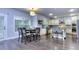 Open concept dining room with wood floors, view of the kitchen and island at 116 Chorley Run, Ellenwood, GA 30294