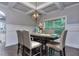 Dining room boasts a coffered ceiling, modern light fixture, and backyard view at 116 Chorley Run, Ellenwood, GA 30294