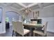 Dining room features hardwood floors, coffered ceiling, modern light fixture and an open plan at 116 Chorley Run, Ellenwood, GA 30294