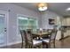 Dining area with a view of the kitchen, cabinets, and stainless steel appliances at 116 Chorley Run, Ellenwood, GA 30294