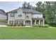 Charming two-story home features manicured lawn, blue front door and well-maintained landscaping at 116 Chorley Run, Ellenwood, GA 30294