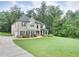 Traditional two-story home with manicured lawn, landscaping and a long driveway at 116 Chorley Run, Ellenwood, GA 30294