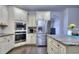 Modern kitchen features stainless steel appliances, beautiful countertops, and custom cabinets at 116 Chorley Run, Ellenwood, GA 30294