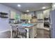 Bright kitchen with an island, pendant lighting, stainless steel appliances, and custom cabinets at 116 Chorley Run, Ellenwood, GA 30294