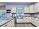 Modern kitchen featuring stainless steel appliances, stylish cabinets, granite countertops and wood floors at 116 Chorley Run, Ellenwood, GA 30294