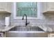 Kitchen sink featuring granite countertops, modern faucet, and subway tile backsplash at 116 Chorley Run, Ellenwood, GA 30294