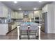 Modern kitchen with stainless steel appliances, custom cabinets, and an island with bar stool seating at 116 Chorley Run, Ellenwood, GA 30294