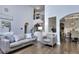 Open-concept living room features hardwood floors and access to dining area at 116 Chorley Run, Ellenwood, GA 30294