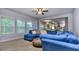 Living room featuring a comfortable blue sectional sofa with view of the kitchen at 116 Chorley Run, Ellenwood, GA 30294