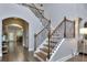 Elegant staircase with wooden handrail and iron spindles overlooks the main floor at 116 Chorley Run, Ellenwood, GA 30294