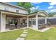 Outdoor patio with a dining area, built in grill, ceiling fans, stone walkway, and manicured backyard at 1442 Pierce Se Ave, Smyrna, GA 30080