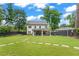 Expansive backyard with stepping stones, lush lawn, covered patio, and a view of the home's exterior at 1442 Pierce Se Ave, Smyrna, GA 30080