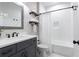 Clean bathroom features a single vanity with granite countertop and a shower-tub combo at 1442 Pierce Se Ave, Smyrna, GA 30080