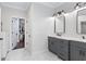Bright bathroom with double vanity, granite countertops, and a view into the walk-in closet with ample storage at 1442 Pierce Se Ave, Smyrna, GA 30080