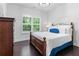 Inviting bedroom with natural light from the shuttered windows, hardwood floors, and a comfortable bed at 1442 Pierce Se Ave, Smyrna, GA 30080