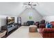 Cozy bonus room with vaulted ceilings, neutral decor, and plush seating for relaxing or entertaining guests at 1442 Pierce Se Ave, Smyrna, GA 30080