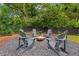 Cozy backyard fire pit area with Adirondack chairs, perfect for outdoor entertaining and relaxation at 1442 Pierce Se Ave, Smyrna, GA 30080