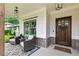 Cozy covered front porch featuring wood columns, seating, and a beautifully decorated front door at 1442 Pierce Se Ave, Smyrna, GA 30080