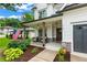 Inviting covered front porch with seating area, an American flag, and well manicured landscaping at 1442 Pierce Se Ave, Smyrna, GA 30080