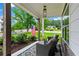 Charming covered front porch with an American flag, seating, and lush landscaping at 1442 Pierce Se Ave, Smyrna, GA 30080