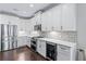 Modern kitchen features stainless steel appliances and sleek white cabinetry at 1442 Pierce Se Ave, Smyrna, GA 30080