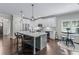 Stylish kitchen featuring white cabinets, a large island with pendant lights, and stainless steel appliances at 1442 Pierce Se Ave, Smyrna, GA 30080