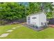 Charming backyard shed with seating area and landscaped surroundings, perfect for storage or a hobby space at 1442 Pierce Se Ave, Smyrna, GA 30080