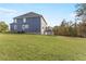 Spacious backyard with lush green lawn and house exterior, great for outdoor activities and relaxation at 3198 Garden Hill Ln, Douglasville, GA 30135