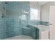A walk-in shower and separate bathtub are visible in this bathroom with blue tiles at 3198 Garden Hill Ln, Douglasville, GA 30135
