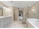 Bathroom featuring double vanity, tub, and glass shower at 3198 Garden Hill Ln, Douglasville, GA 30135