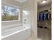 Bathroom features soaking tub and view to the closet at 3198 Garden Hill Ln, Douglasville, GA 30135