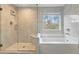 Bright bathroom with glass-enclosed shower and soaking tub at 3198 Garden Hill Ln, Douglasville, GA 30135