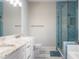 This bathroom has a glass shower, double sinks and white cabinets at 3198 Garden Hill Ln, Douglasville, GA 30135