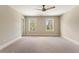 Bright bedroom features neutral carpet, ceiling fan, and double windows at 3198 Garden Hill Ln, Douglasville, GA 30135