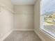 A walk-in closet with wire shelving and window provides ample storage and natural light at 3198 Garden Hill Ln, Douglasville, GA 30135