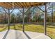 View from covered patio overlooking lush green yard, perfect for outdoor relaxation and entertaining at 3198 Garden Hill Ln, Douglasville, GA 30135