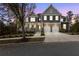 Beautiful two-story home with stone accents and a well-manicured front yard at twilight at 3198 Garden Hill Ln, Douglasville, GA 30135