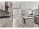 Bright open kitchen features stainless appliances, granite countertops, gray cabinetry and subway tile backsplash at 3198 Garden Hill Ln, Douglasville, GA 30135