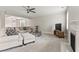 Comfortable living room with fireplace, ceiling fan, and natural light creates a relaxing space at 3198 Garden Hill Ln, Douglasville, GA 30135