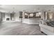 Open-concept living space featuring a modern kitchen, fireplace, and light gray flooring at 3198 Garden Hill Ln, Douglasville, GA 30135